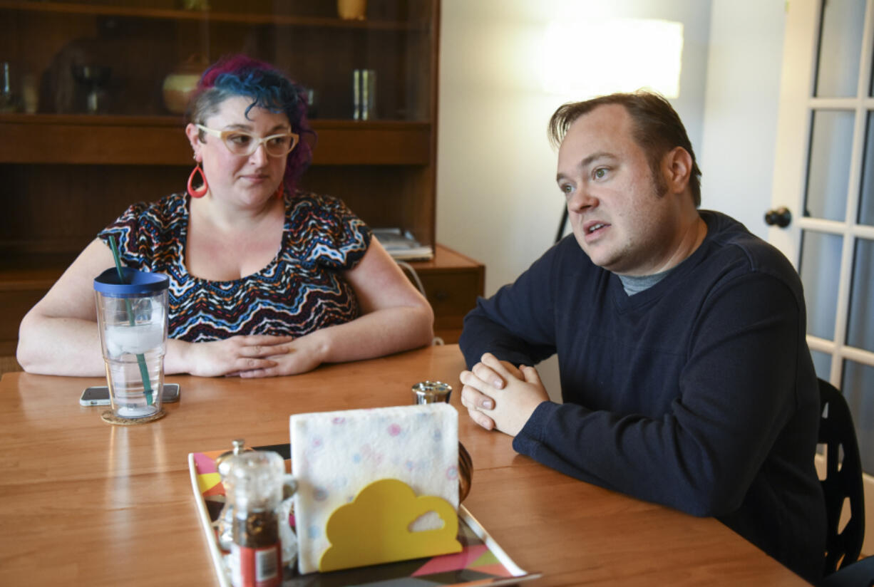 Alison Gootee listens as her husband, Zachery Scalf, recounts when his UPS delivery truck was stolen during a delivery to Hazel Dell. Scalf was fired from UPS shortly after the incident and is currently looking for a new job.