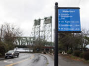 A wayfinding sign next to the intersection of Columbia Way and Columbia Street is visible near downtown Vancouver.