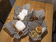 A Monte Cristo sandwich, clockwise from left, Beignets, Boudin Balls and Shrimp Pistolette are among the offerings at La Oie Cajun Cuisine, which is parked outside of Brothers Cascadia Brewing.