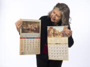 Cyrilla Gleason of Vancouver holds two of her vintage calendars — 1945, left, and 1973 — on Thursday. Both are usable in 2018.