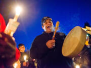 Rick Bear Montoya, a friend of James Rennells, sings a song for Rennells during a candlelight vigil Saturday near Leverich Park in Vancouver. Rennells was found dead near the park Wednesday after being missing for nearly a week.