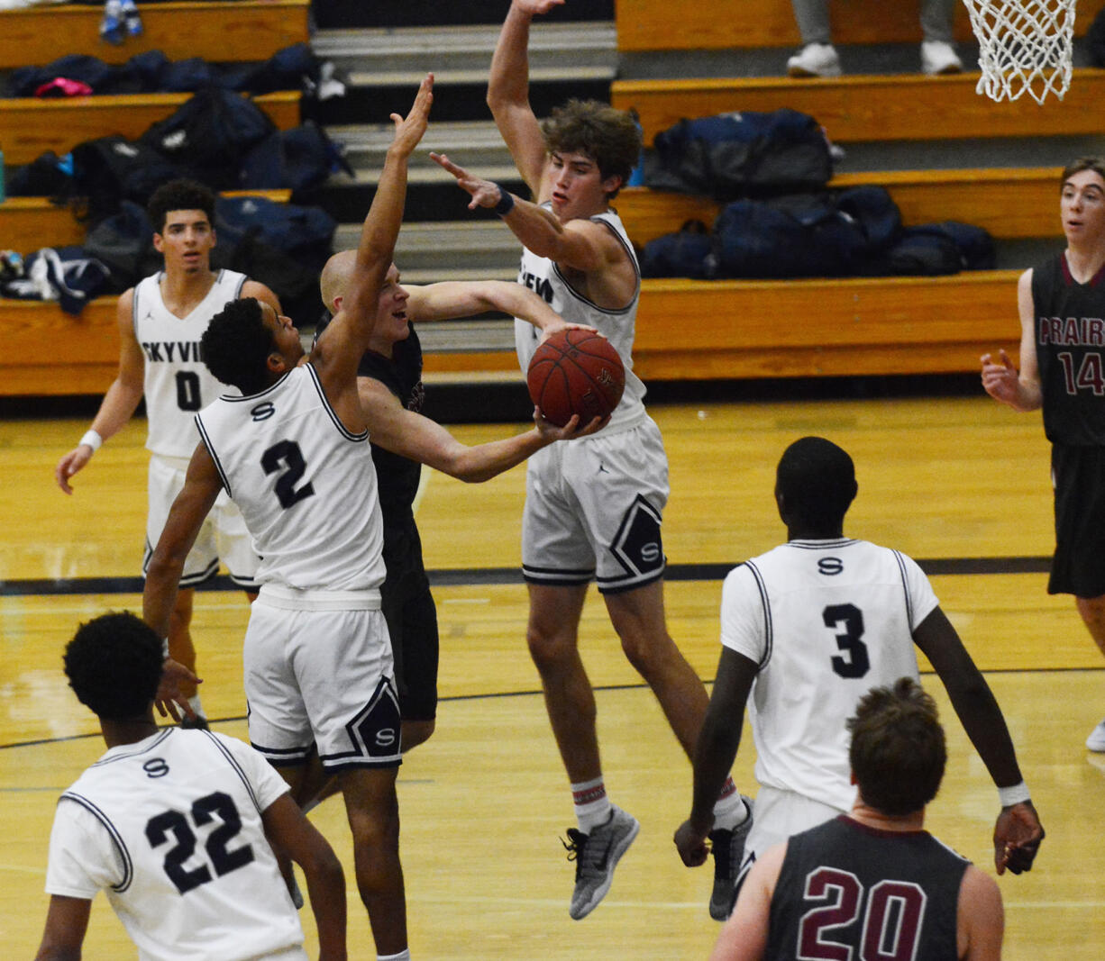 Prairie guard Kam Osborn goes up with a contested layup against two Skyview defenders. The Storm defeated Prairie 57-52 at Skyview High School on Tuesday night to improve to 2-0 on the season.