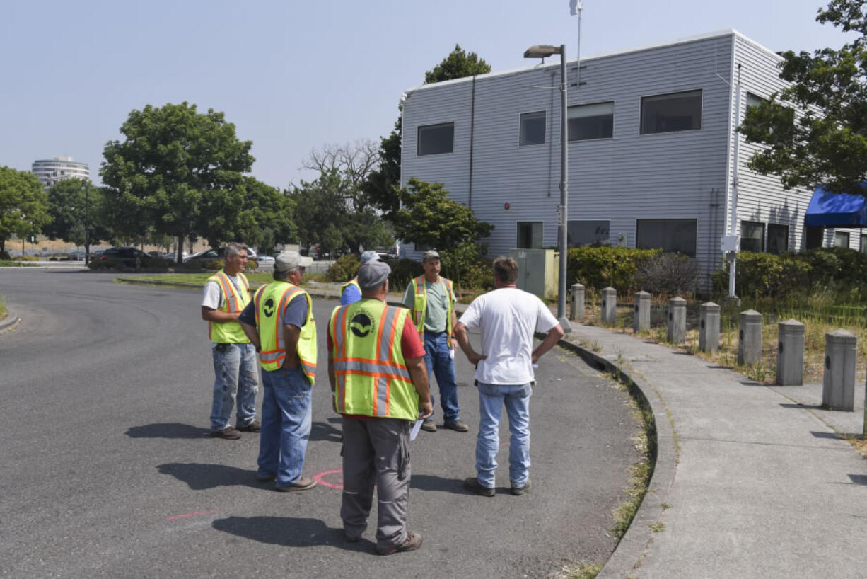 Port of Vancouver officials inspect property on Columbia Way where construction has been proposed for The AC by Marriott hotel on Aug. 8. A pre-application document was filed with the city of Vancouver this week.