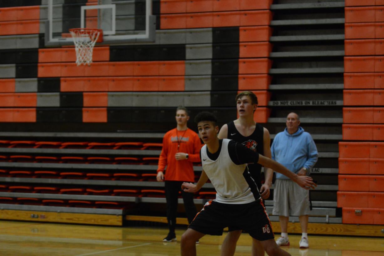 Six-foot-8 freshman Kaden Perry, front, and senior captain Elijah Parker battle for a rebound.