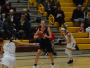 Camas wing Jordyn Wilds looks to pass against Prairie earlier this season. The Papermakers are the defending 4A Greater St. Helens League champions, but will have to adjust lineups after losing starting post Madison Freemon to a knee injury.