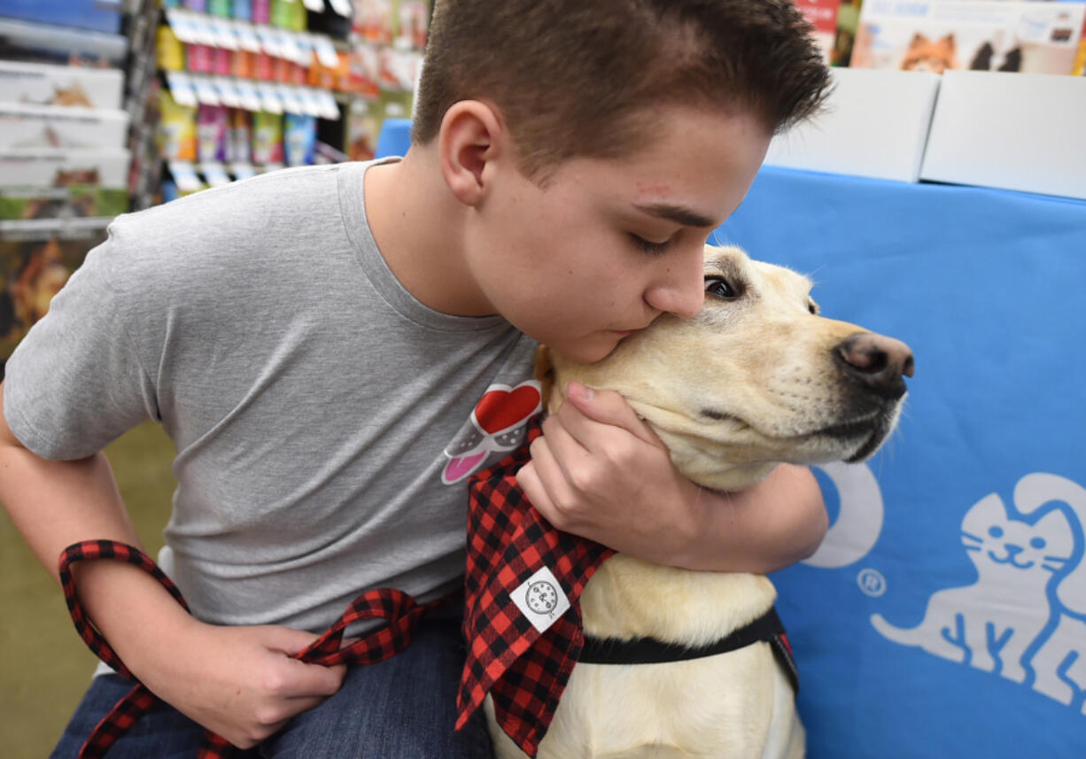 Parker Rogers, 14, who has epilepsy, with his service dog, Toby.