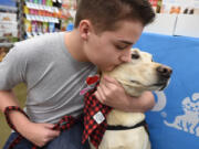 Parker Rogers, 14, who has epilepsy, with his service dog, Toby.