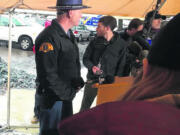 Washington State Patrol Trooper Will Finn preparing the media for a press briefing with Gov. Jay Inslee on Dec. 19, 2017, near the scene of the Amtrak derailment.