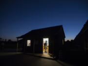 Costumed re-enactor Mike Riley waits for visitors at the entrance to Fort Vancouver National Historic Site on Oct. 28.