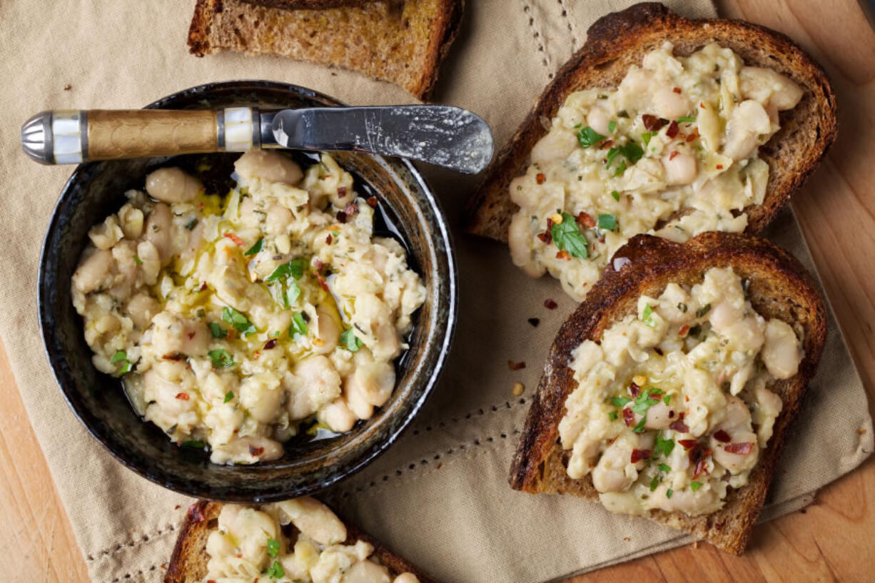 Garlic-Rosemary White Bean Toasts take all of 15 minutes to whip up with ingredients that are easy to keep on hand — so it’s perfect for surprise guests.