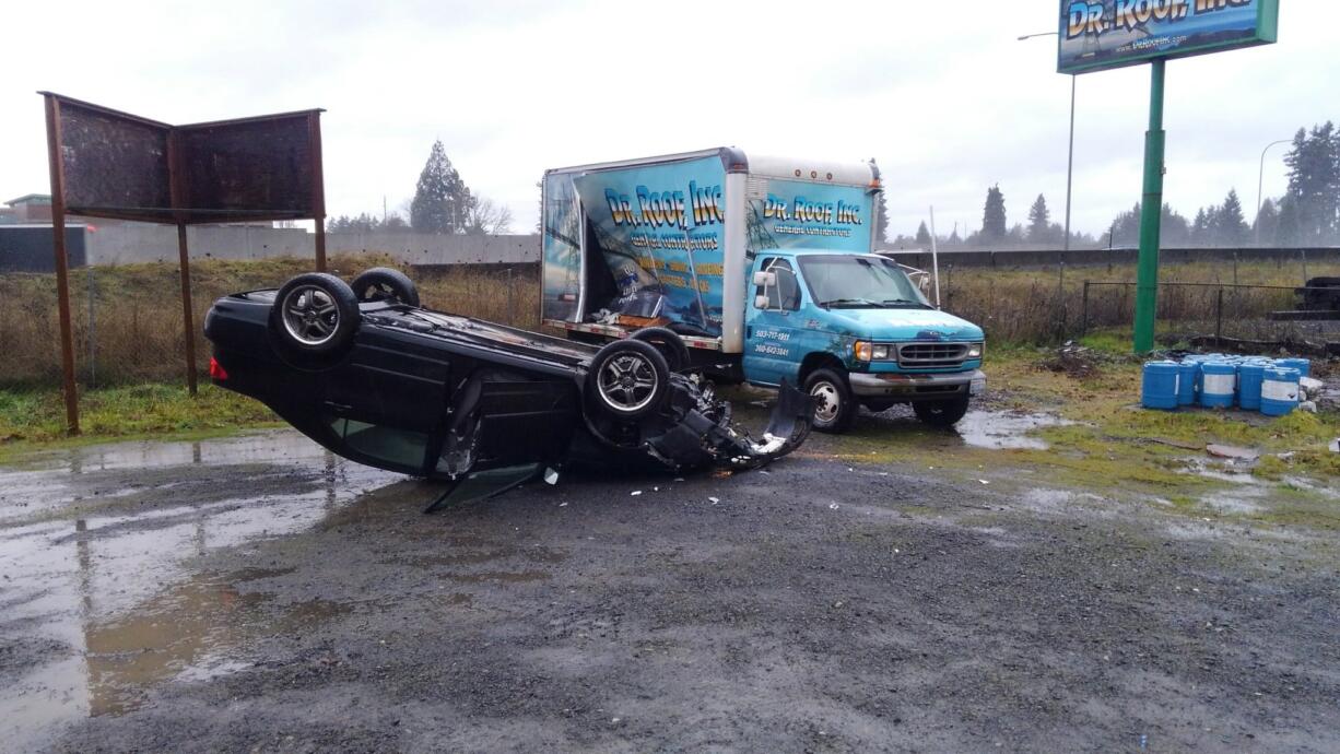 A vehicle went airborne and struck a Dr. Roof cargo box truck before landing on its top, according to troopers at the scene. The female driver suffered minor injuries.