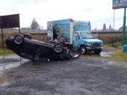 A vehicle went airborne and struck a Dr. Roof cargo box truck before landing on its top, according to troopers at the scene. The female driver suffered minor injuries.