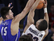 Creighton forward Martin Krampelj (15) and Gonzaga guard Zach Norvell Jr. go after a rebound during the second half of an NCAA college basketball game in Spokane, Wash., Friday, Dec. 1, 2017. Gonzaga won 91-74.