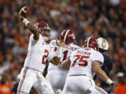 Alabama quarterback Jalen Hurts throws the ball during the second half of the Iron Bowl in Auburn, Ala. The Associated Press voters prefer Alabama over Ohio State. In the final Top 25 of the 2017 regular season, the Crimson Tide was No. 4 and the Buckeyes were No. 5.