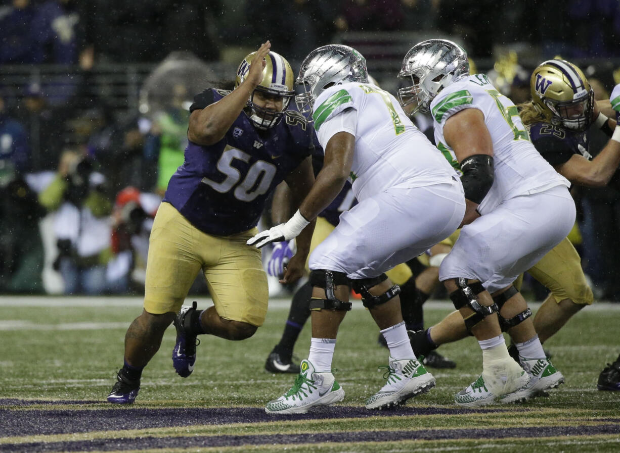 Washington defensive lineman Vita Vea, left, lines up against Oregon in the first half of an NCAA college football game, Saturday, Nov. 4, 2017, in Seattle. (AP Photo/Ted S.