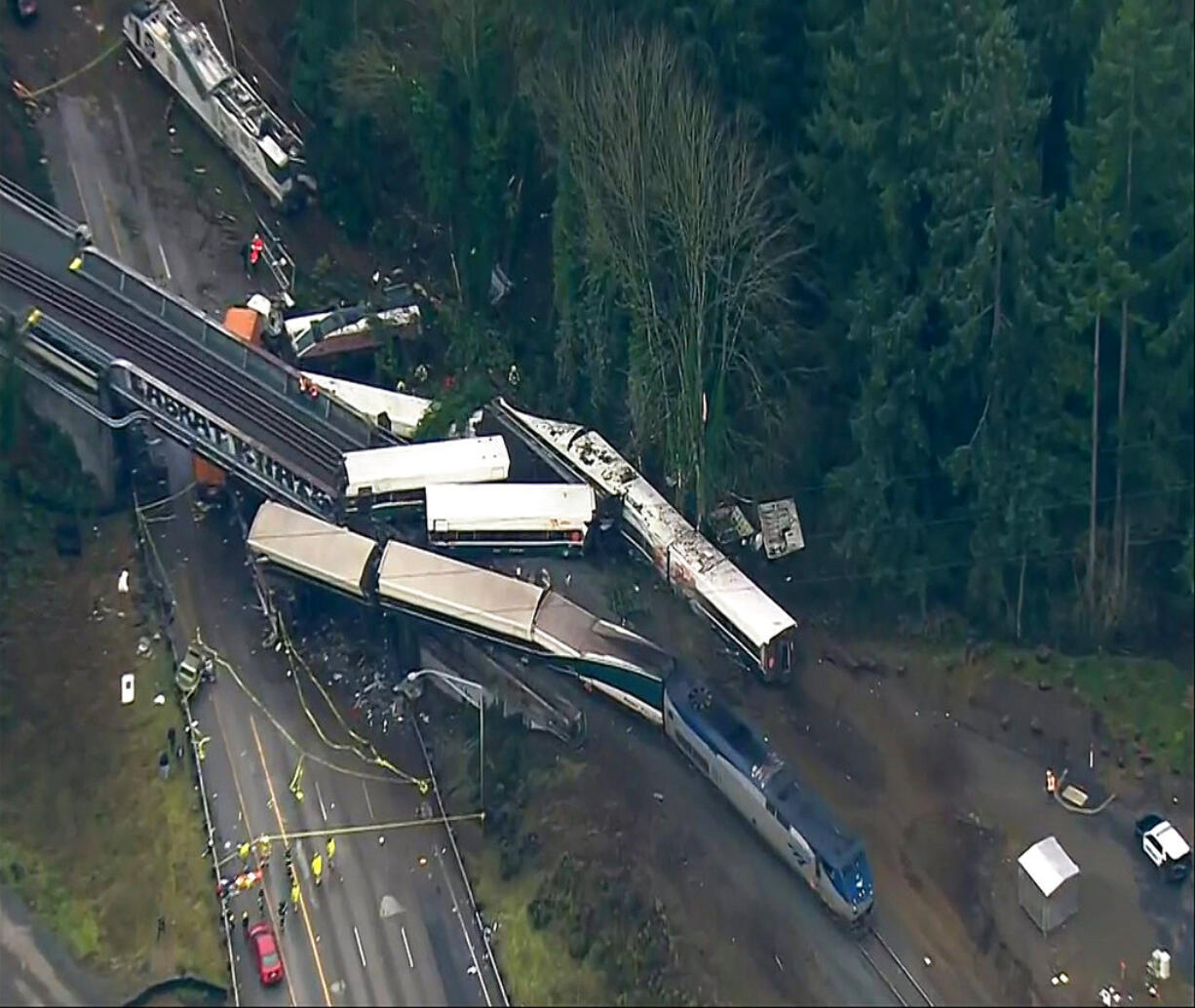 This aerial image from video provided by KOMO-TV, shows the site of an Amtrak train that derailed south of Seattle on Monday, Dec. 18, 2017. Authorities reported "injuries and casualties." The train derailed about 40 miles (64 kilometers) south of Seattle before 8 a.m., spilling at least one train car on to busy Interstate 5.