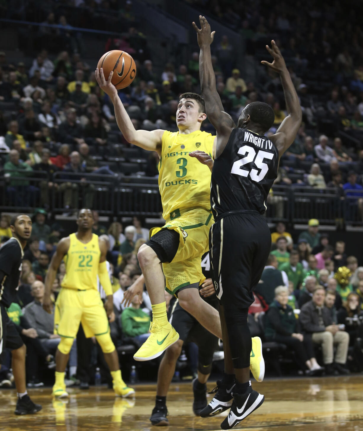 Oregon's Payton Pritchard, left, drives past Colorado's McKinley Wright IV during the second half of an NCAA college basketball game Sunday, Dec. 31, 2017, in Eugene, Ore.