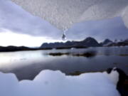 An iceberg melts in Kulusuk, Greenland near the arctic circle. A new report finds permafrost in the Arctic is thawing faster than ever before. The annual report card released Tuesday also finds water is warming and sea ice is melting at the fastest pace in 1,500 years at the top of the world.