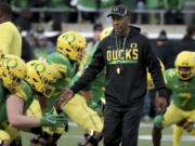 FILE - In this Nov. 18, 2017, file photo, Oregon head coach Willie Taggart, center, greets his players during warmups before an NCAA college football game against Arizona in Eugene, Ore. A person with direct knowledge of the situation says Willie Taggart has agreed to become Florida State's next football coach. The person says Taggart has called a team meeting to inform his Oregon players he is heading to Tallahassee to replace Jimbo Fisher. Florida State. The person spoke to The Associated Press Tuesday, Dec. 5, 2017, on condition of anonymity because neither school had announced the move.