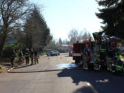 Firefighters from Fire District 6 and the Vancouver Fire Department work the scene of a house fire at Northwest Bernie Drive on Thursday, Dec. 7, 2017. A fire district spokesman said the fire was contained within five minutes.