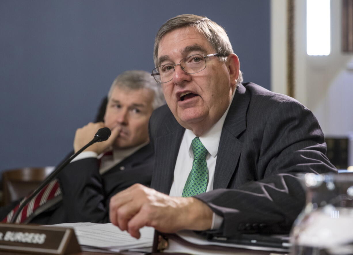 Health Subcommittee Chairman Michael C. Burgess, R-Texas, joined at left by Rep. Rob Woodall, R-Ga., speaks about funding for the CHIP program as the House Rules Committee meets to work on a government funding bill, on Capitol Hill, in Washington,= on Thursday. With a government shutdown clock ticking toward a midnight Friday deadline, House Republican leaders struggled on Wednesday to unite the GOP rank and file behind a must-pass temporary spending bill. (AP Photo/J.