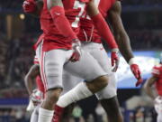 Ohio State safety Damon Webb (7) celebrates his touchdown with teammate Jalyn Holmes (11) during the first half of the Cotton Bowl NCAA college football game against Southern California in Arlington, Texas, Friday, Dec. 29, 2017.