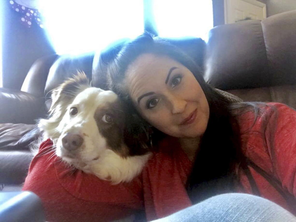 Lindsy Bray is shown with her Australian shepherd named Dexter. A deal has been reached that will spare the life of Dexter, ordered put to death after he bit a 12-year-old girl.