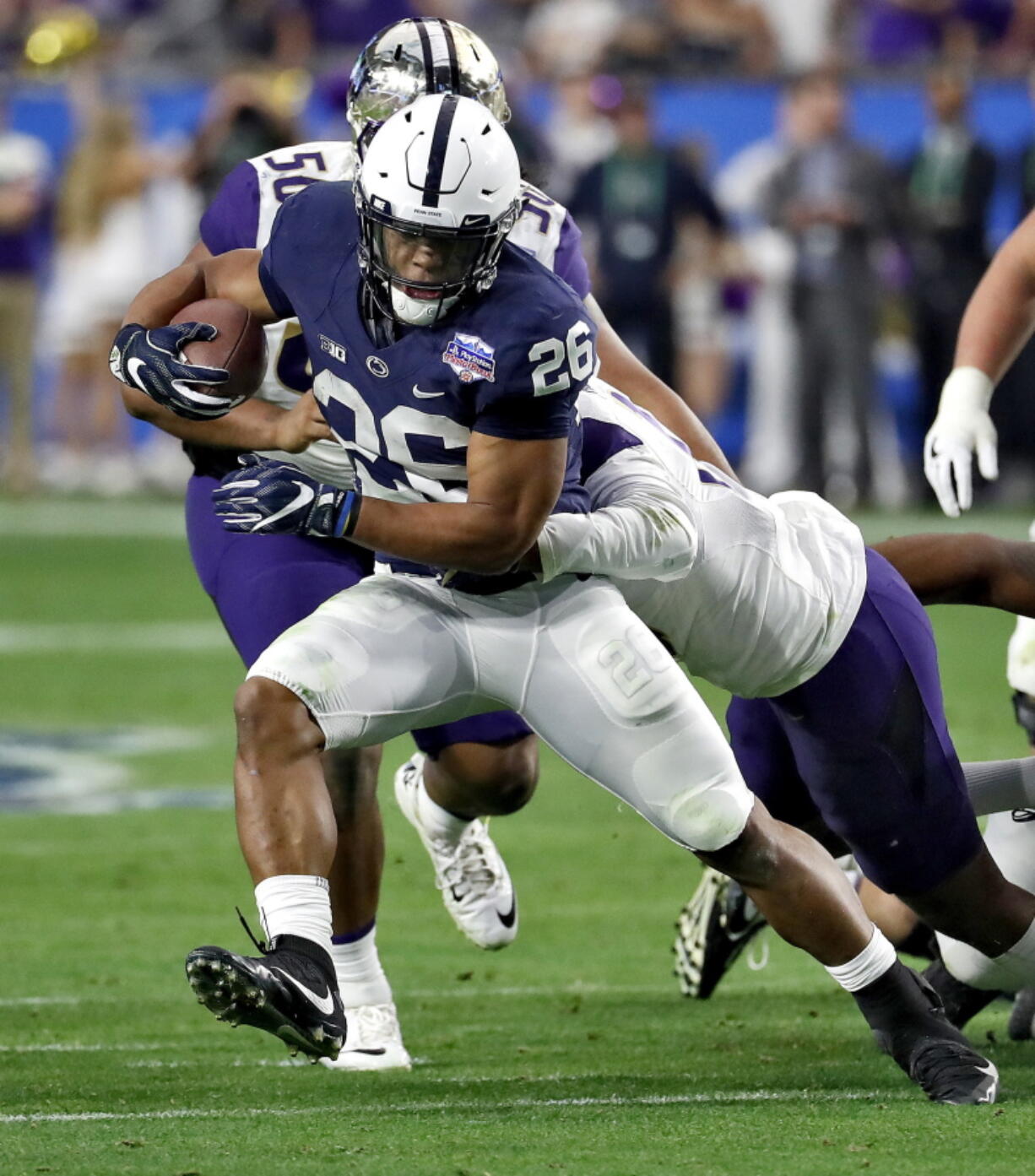 Penn State running back Saquon Barkley (26) runs against Washington during the second half of the Fiesta Bowl NCAA college football game, Saturday, Dec. 30, 2017, in Glendale, Ariz.