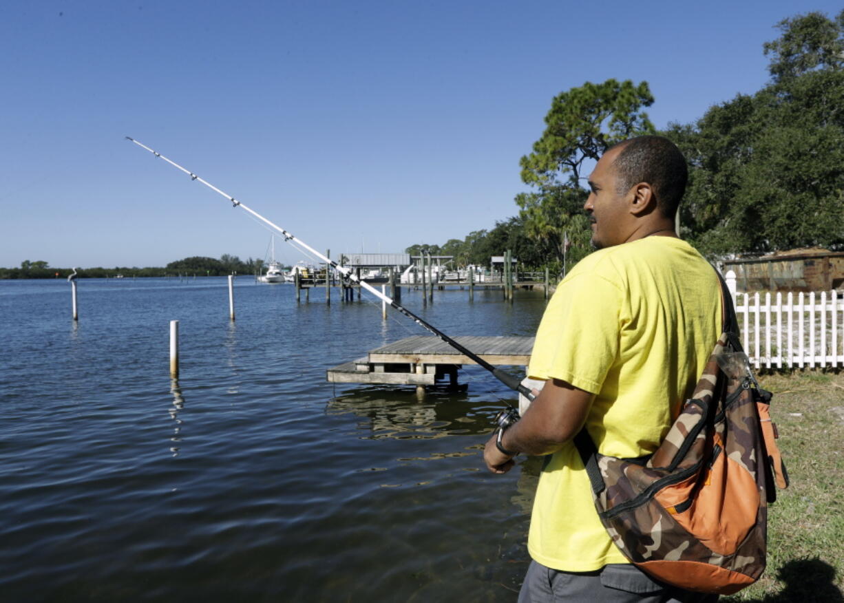 Anthony Stansbury fishes Nov. 30 in the Anclote River in Tarpon Springs, Fla. He moved down the street from the Anclote River in Florida, within a mile of a Superfund site.