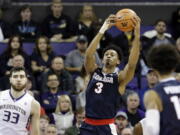 Gonzaga’s Johnathan Williams (3) grabs a rebound as Washington’s Sam Timmins (33) looks on in the first half of an NCAA college basketball game Sunday, Dec. 10, 2017, in Seattle.