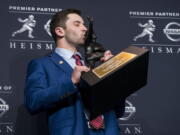 Oklahoma quarterback Baker Mayfield, winner of the Heisman Trophy, kisses the trophy Saturday, Dec. 9, 2017, in New York.