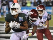 Michigan State wide receiver Cody White (7) makes a touchdown catch in front of Washington State safety Jalen Thompson (34) and cornerback Darrien Molton, rear, during the first half of the Holiday Bowl NCAA college football game Thursday, Dec. 28, 2017, in San Diego.