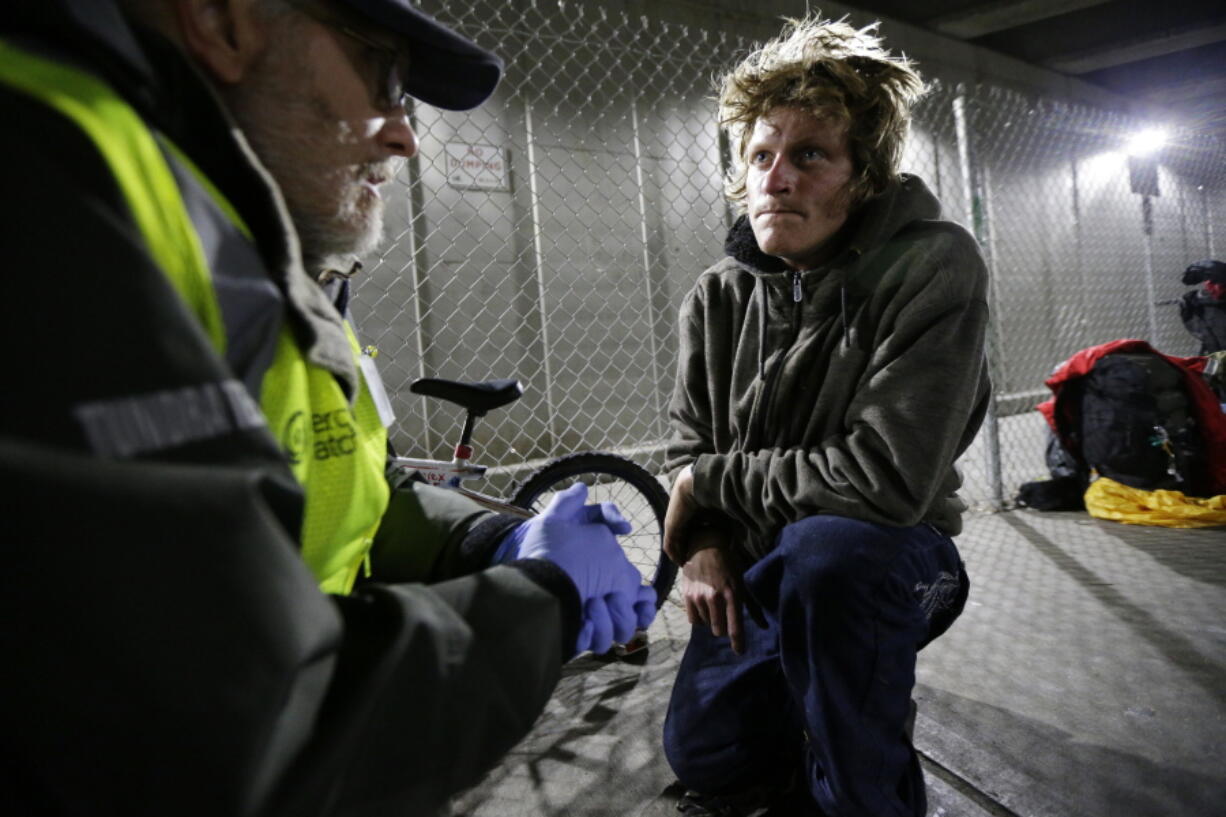 Alex Rehn, right, a homeless heroin and meth addict, talks Oct. 12 with Tim McNamara, a doctor volunteering with MercyWatch, an outreach group that serves the medical and other needs of the homeless population in Everett. Ted S.