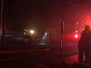 Family members embrace Wednesday night after fire damaged their home at 6402 N.E. 66th Ave., in Vancouver’s Walnut Grove neighborhood.