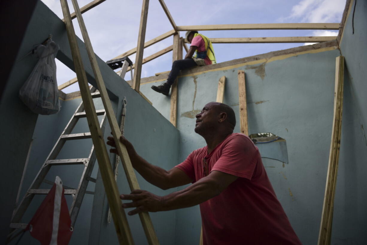 Pedro Deschamps helps workers hired by FEMA to carry out the installation of a temporary awning roof at his house, which suffered damage during Hurricane Maria, in San Juan, Puerto Rico. The Department of Homeland Security’s internal watchdog says his office will be investigating how a tiny Florida company won more than $30 million in contracts for desperately needed relief supplies following Hurricane Maria. The Associated Press first reported last month that Bronze Star LLC failed to deliver the emergency tarps and plastic sheeting needed to cover tens of thousands of Puerto Rican homes damaged by the storm’s winds. The Federal Emergency Management Agency eventually terminated the contracts without paying any money.