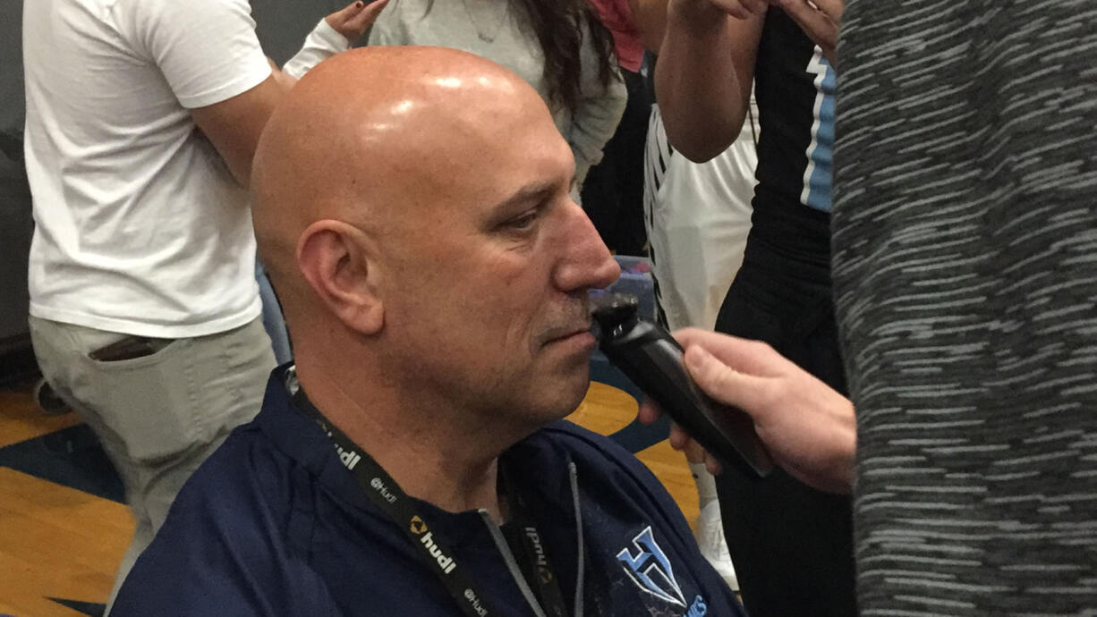 Hockinson football coach Rick Steele, as a part of a bet, had his mustache shaved by his players after they presented the state championship trophy to the high school on Friday, December 15.