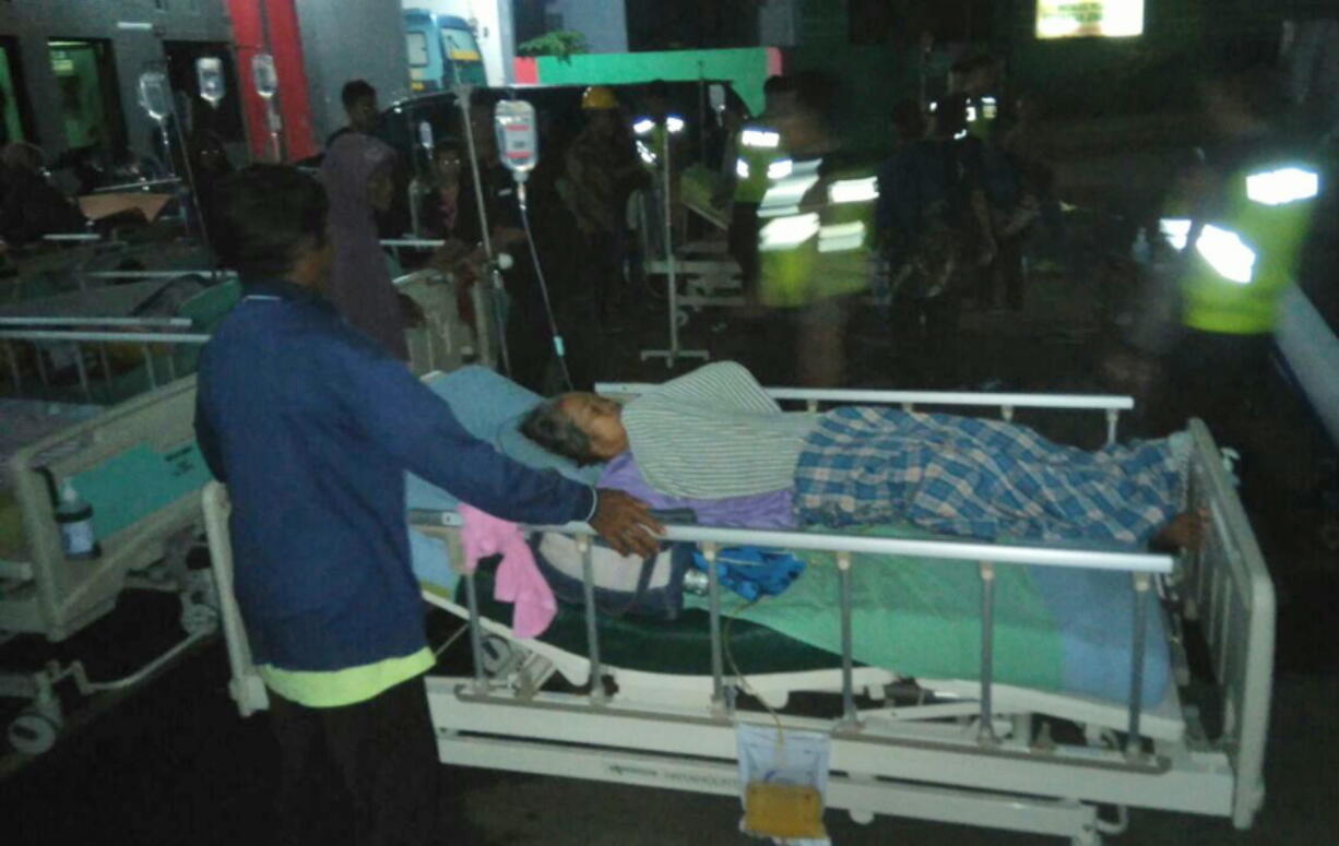 Patients are evacuated outside a hospital following an earthquake in Banyumas, Central Java, Indonesia, Saturday, Dec. 16, 2017. A strong earthquake shook the island of Java just before midnight Friday triggering a tsunami warning for parts of the main island’s coastline.