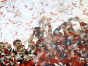 Toronto FC captain Michael Bradley hoists the trophy as the team celebrates its win over the Seattle Sounders in the MLS Cup final in Toronto, Saturday, Dec. 9, 2017.