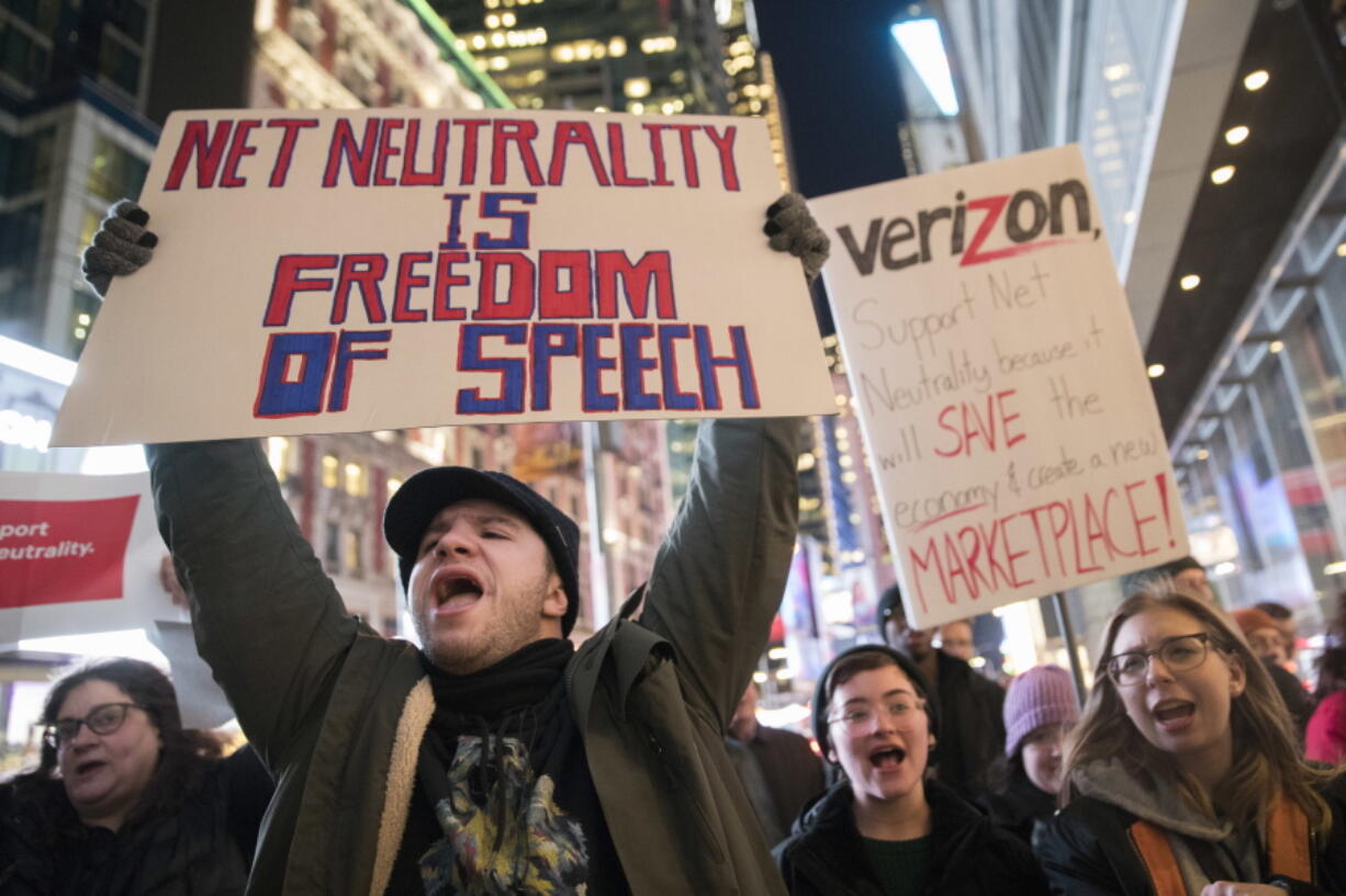 Demonstrators rally Dec. 7 in support of net neutrality outside a Verizon store in New York.