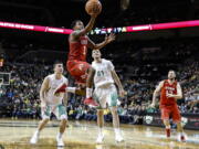 Utah guard Justin Bibbins (1) drives to the basket against Oregon during an NCAA college basketball game Friday, Dec. 29, 2017, in Eugene, Ore.