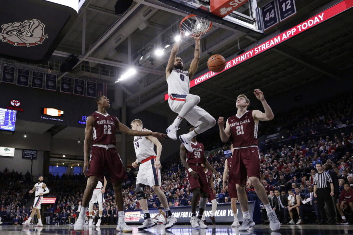 Gonzaga guard Silas Melson (0) dunks during the first half of an NCAA college basketball game against Santa Clara in Spokane, Wash., Saturday, Dec. 30, 2017.