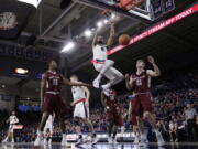 Gonzaga guard Silas Melson (0) dunks during the first half of an NCAA college basketball game against Santa Clara in Spokane, Wash., Saturday, Dec. 30, 2017.