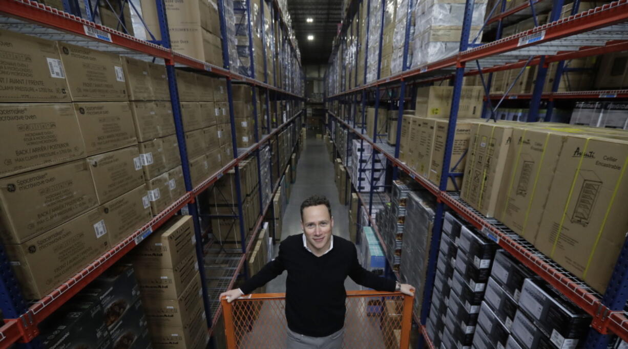 In this Wednesday, Dec. 20, 2017, photo, Jon Abt poses for a portrait in the warehouse of the Abt family’s single appliance and furniture store in Glenview, Ill. He says Abt Electronics held its own this holiday season, up against competition like Amazon, Walmart, Best Buy and more, by capitalizing on advantages it has over the big guys.