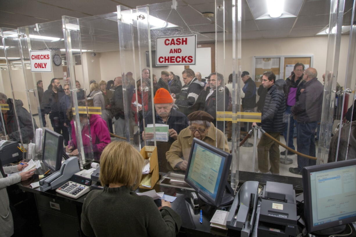 People line up at the Town of Hempstead tax receiver’s office in New York to pay their real estate taxes before the end of the year, hoping for one last chance to take advantage of a major tax deduction before it is wiped out in the new year. In Hempstead, town Tax Receiver Donald Clavin said “thousands” of people packed his office Tuesday trying to pay their 2018 property and school taxes a year in advance.