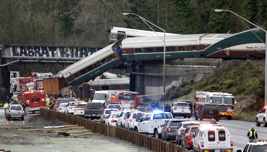 In this Dec. 18, 2017, file photo, cars from an Amtrak train lay spilled onto Interstate 5 below as some remain on the tracks above in DuPont, Wash. The train derailment which left three people dead was among the top news stories in Washington state in 2017.