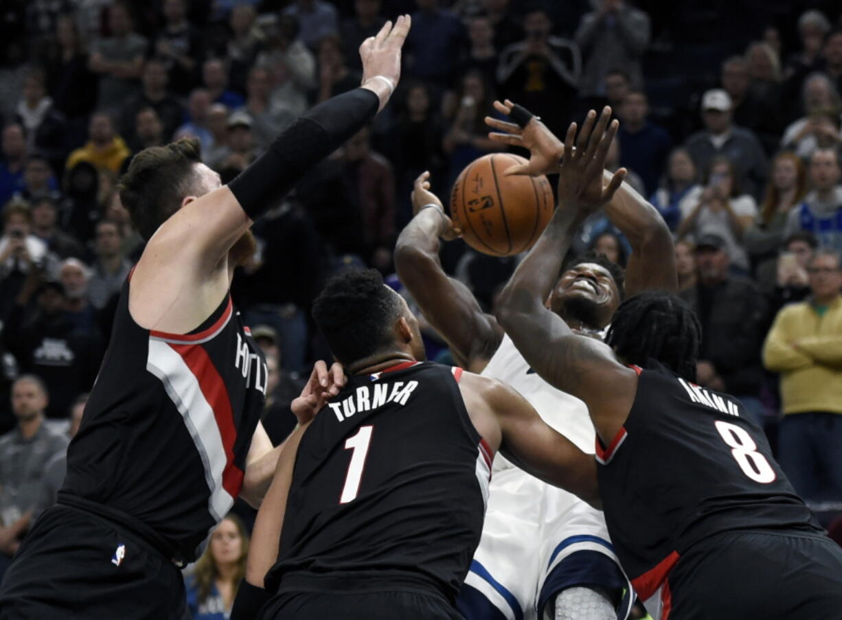 Portland Trail Blazers, from left, Jusuf Nurkic, Evan Turner and Al-Farouq Aminu swarm Minnesota Timberwolves guard Jimmy Butler.