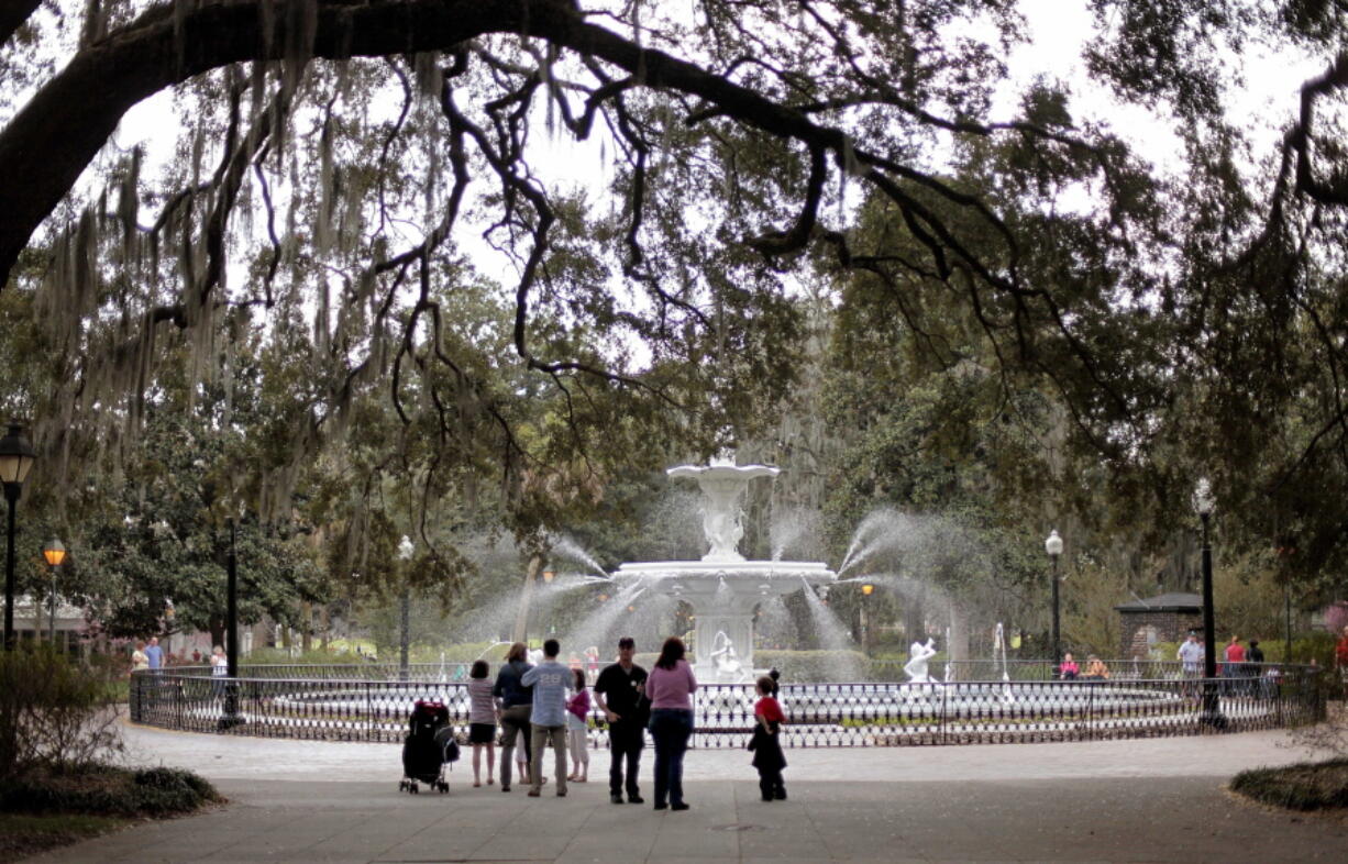 People gather Feb. 21, 2011, at the Forsythe Park fountain in the historic district of Savannah, Ga. Lured by the city’s time-capsule collection of antebellum homes and manicured public squares, tourists spent an estimated $2.8 billion here in 2016.