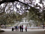 People gather Feb. 21, 2011, at the Forsythe Park fountain in the historic district of Savannah, Ga. Lured by the city’s time-capsule collection of antebellum homes and manicured public squares, tourists spent an estimated $2.8 billion here in 2016.