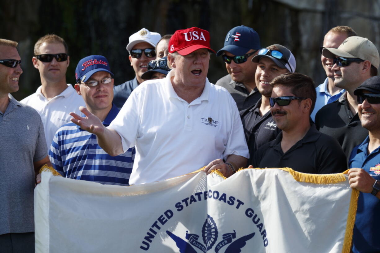 President Donald Trump speaks Friday as he meets with members of the U.S. Coast Guard, who he invited to play golf, at Trump International Golf Club, in West Palm Beach, Fla.