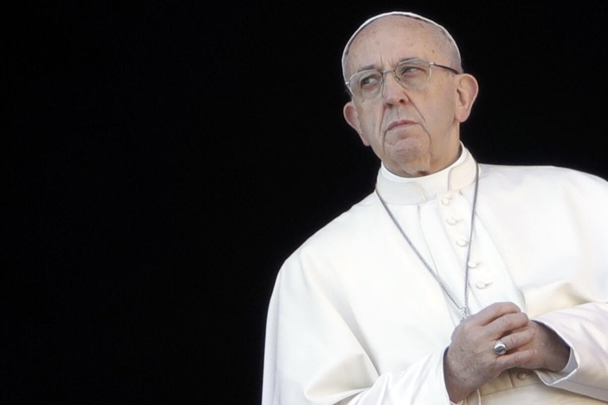 Pope Francis joins his hands during the Urbi et Orbi (Latin for ‘to the city and to the world’) Christmas’ day blessing from the main balcony of St. Peter’s Basilica at the Vatican on Monday.